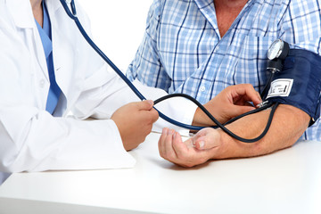 Doctor checking patient blood pressure.