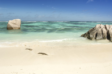 High angle view of the famous Anse Source D'Argent beach in La Digue, Seychelles. Turquoise water and black boulders granite rocks.
