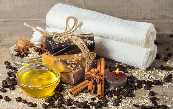 Handmade soap with coffee beans and spices on a wooden backgroun