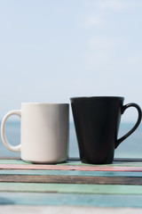 Black and white coffee cup on vintage table blurred background