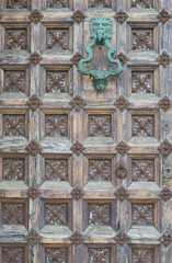 Old door handle with carved wood and iron