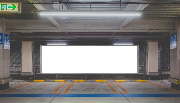 Parking garage underground interior with blank billboard