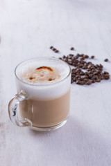 Coffee cup on grunge white wooden background