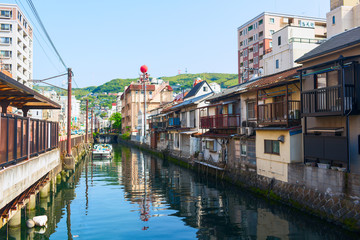 Fototapeta na wymiar Old Town district in Nagasaki City. Artificial canal flows into the Japanese Sea