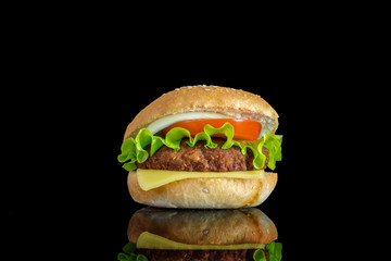 hamburger with fresh leaf lettuce cheese slice chop tomatoes and onion rings with reflection isolated on white background 

