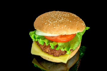 hamburger with fresh leaf lettuce cheese slice chop tomatoes and onion rings with reflection isolated on white background 
