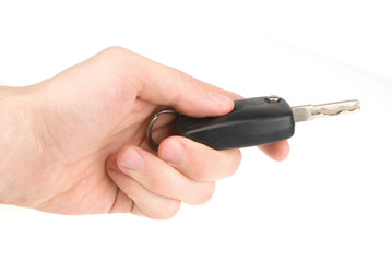 Hand holding car keys isolated on white background