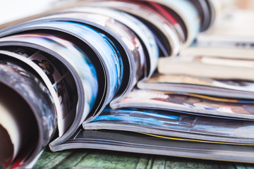 stack of open colorful magazines. information - 90571126