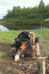 Stone fireplace for handicraft Russian bath on the bank of the northern river. Kola Peninsula, Russia.
