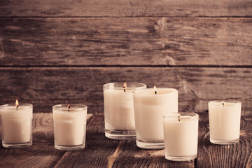 scented candles on old wooden background