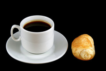cup of coffee with a croissant  isolated on a black background
