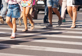 feet of the pedestrians crossing on city street