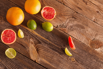 Set of sliced citrus fruits over wooden background