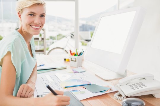 Smiling creative businesswoman looking at the camera