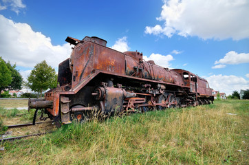 Fototapeta na wymiar Scenic HDR image of an old ruined locomotive.