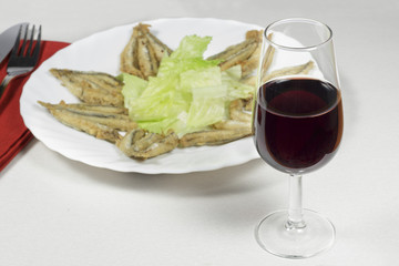 Wineglass of Rioja Gran Reserva in front of dish of breaded anchovies