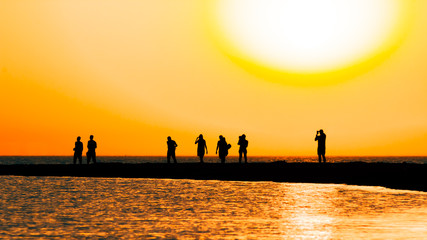 Picturesque sunset over the sand spit in the sea