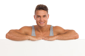 Obraz premium Handsome Man Leans On A Banner