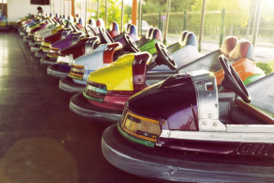 Long row of colorful bumper cars parked in an amusement park