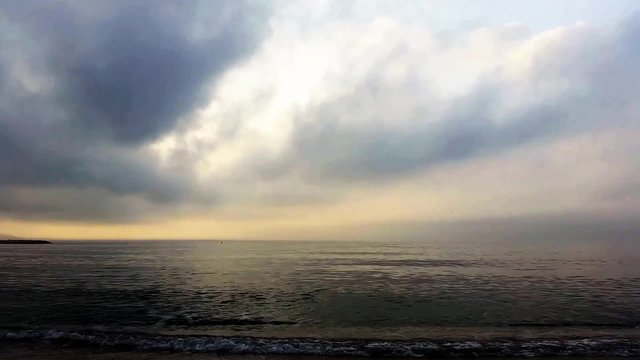 beach with cloudy sky at a fast camera