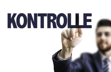 Business man pointing the text: Control (in German)