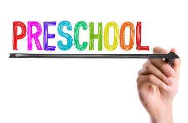Hand with marker writing the word Preschool