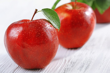 Ripe red apples on table close up