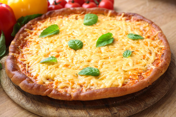 Cheese pizza with vegetables on table close up