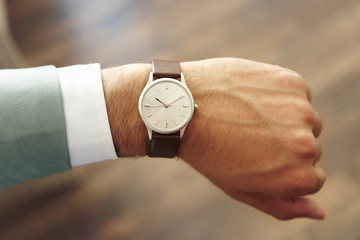 Businessman looking at his watch in office
