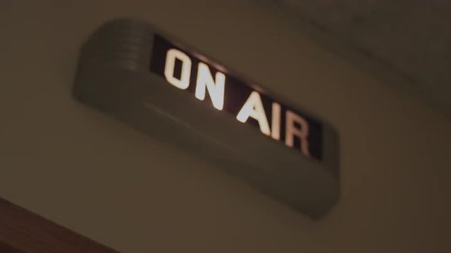 A lit up on-air sign
