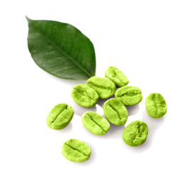 Heap of green coffee beans with leaf isolated on white