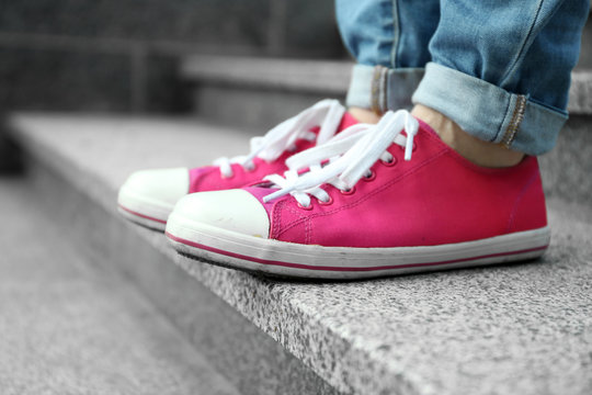 Female Feet In Pink Gumshoes On Stone Stairs