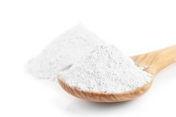 Wheat flour in wooden spoon isolated on white