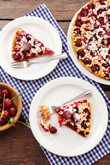 Tasty homemade pie with cherries on table close up