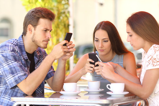 Group Of Phone Addicted Friends In A Coffee Shop