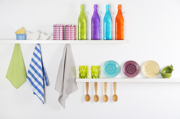 Kitchen utensils on wooden shelves, close up