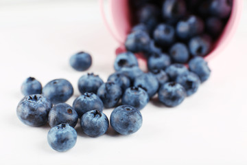 Tasty ripe blueberries in bucket on table close up