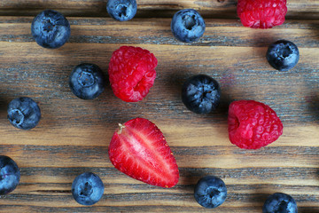 Tasty ripe berries on wooden table close up
