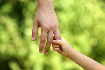 Father and daughter hands outdoors