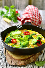 Omelet with tomatoes and broccoli.