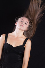 Pretty woman with long hair, slinging her hair