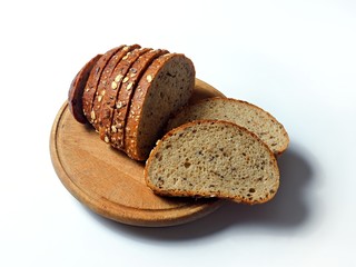 multigrain sliced bread on a wooden round plank