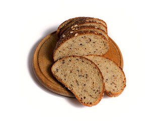 multigrain sliced bread on a wooden round plank on white background