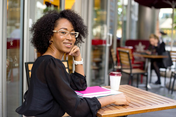 young woman sitting outside a coffeeshop