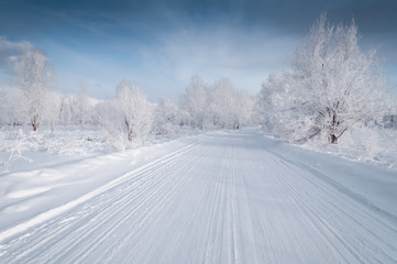 Fototapeta na wymiar Winter landscape with snowed up road