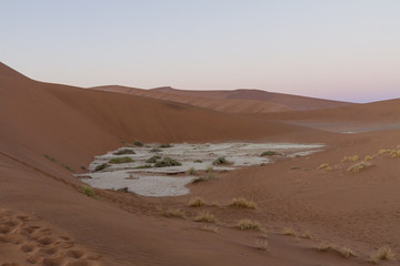 Sunrise over the dunes at Sossousvlei, looking down at a clay pan. 