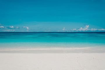blue sky with sea and beach - soft focus with film filter