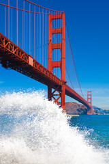 Golden Gate Bridge with big wave splash and spray in the foregro
