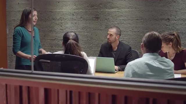 Woman leading a small business meeting
