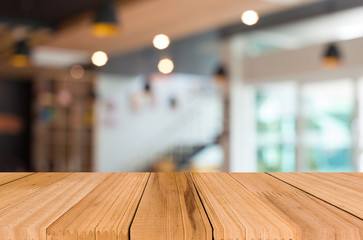 Selected focus empty brown wooden table and Coffee shop blur bac